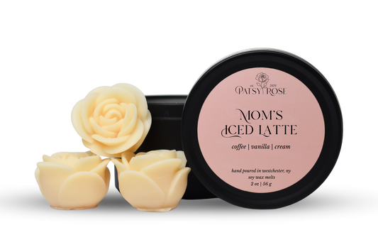 Hand-poured, rose shaped soy wax melts made by Patsy Rose with black tins and a peach label that says "Mom's Iced Latte" with scent notes of "coffee, vanilla, cream".