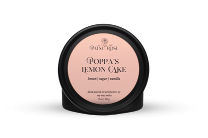 Hand-poured soy wax melts made by Patsy Rose with black tins and a peach label that says "Poppa's Lemon Cake" with scent notes of "lemon, sugar, vanilla".
