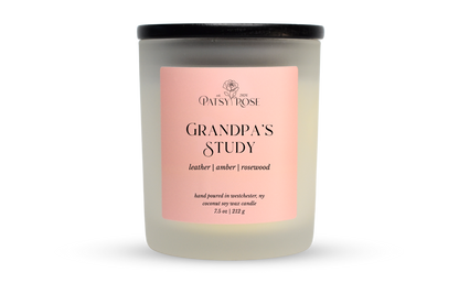 A 7.5 oz soy wax candle by Patsy Rose in the 'Grandpa's Study' 'leather | amber | rosewood' scent. The candle is in a frosted glass jar with a black lid and a peach-pink label, set against a plain white background.